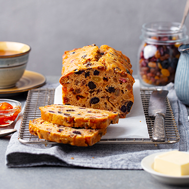 A puréed and simmering carrot soup in a pot with a spoon