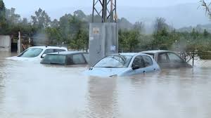 A puréed and simmering carrot soup in a pot with a spoon