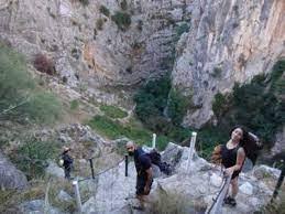 People struggle against the wind and rain in Malmö, Sweden, after a storm reached southern Sweden, Saturday Oct. 4, 2025. (Johan Nilsson/TT via AP)